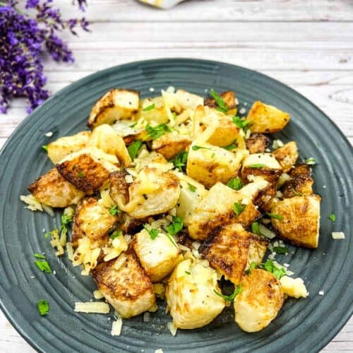 A plate with roasted kohlrabi and parmesan on it.