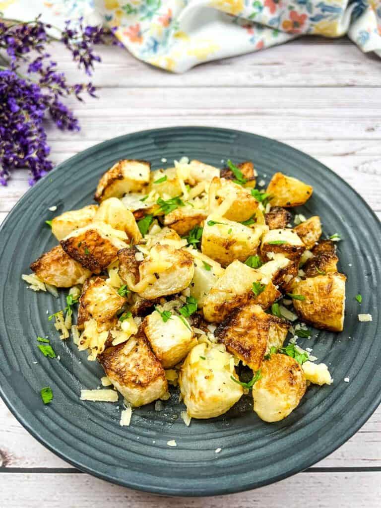 A plate with roasted kohlrabi and parmesan on it.