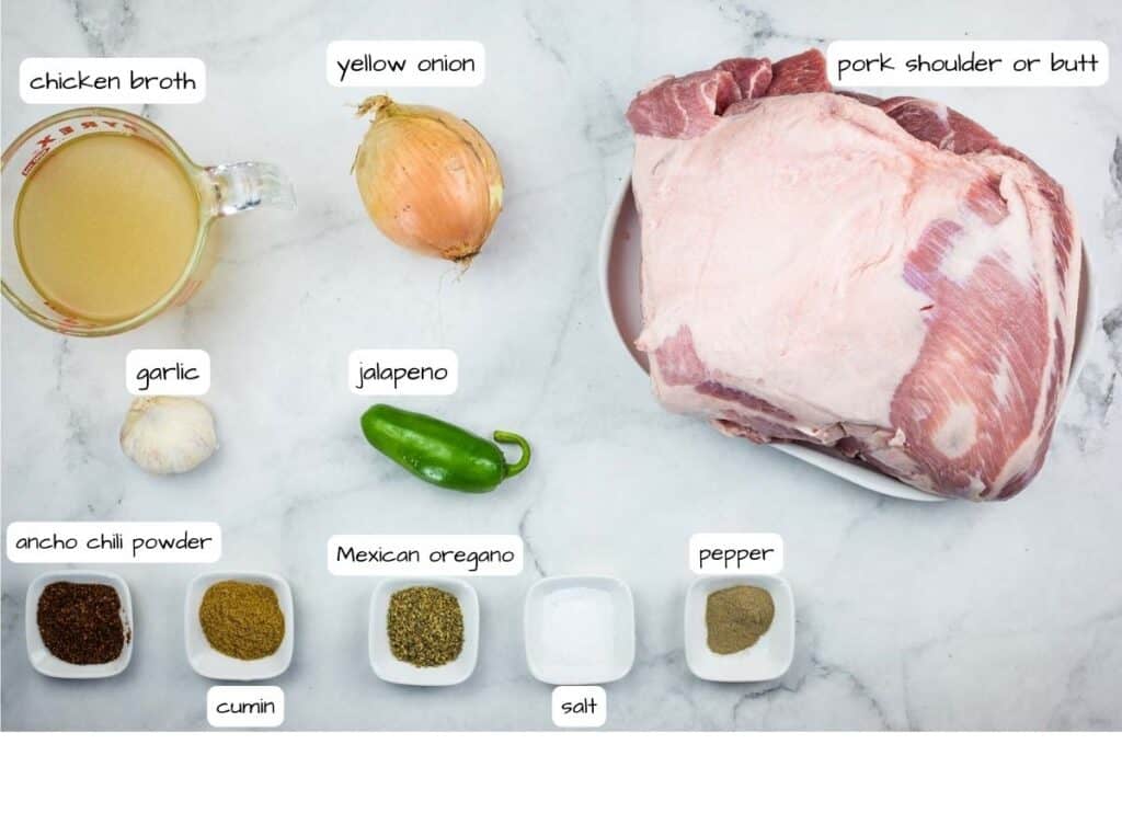 Ingredients for a roasted pork recipe on a marble countertop.