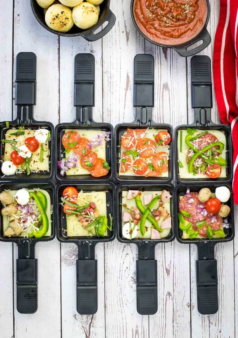 A set of black trays with food in them.