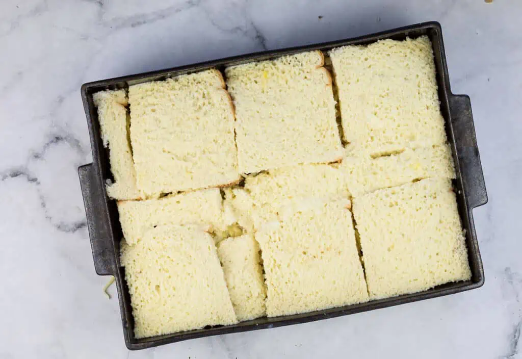 Bread slices in a pan on a marble table.