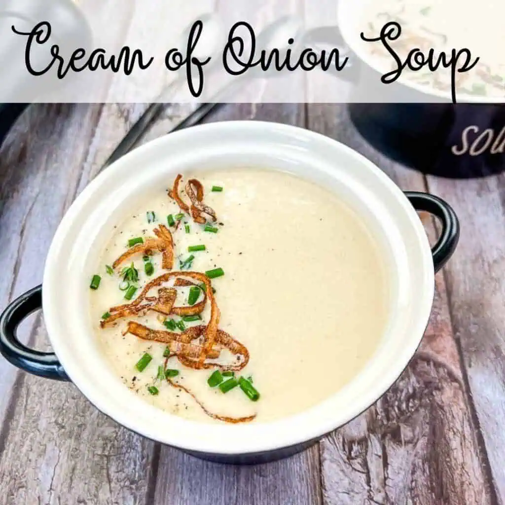 Cream of onion soup in a bowl on a wooden table.
