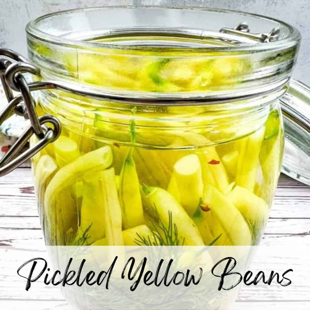 Pickled yellow beans in a jar with the text pickled yellow beans.