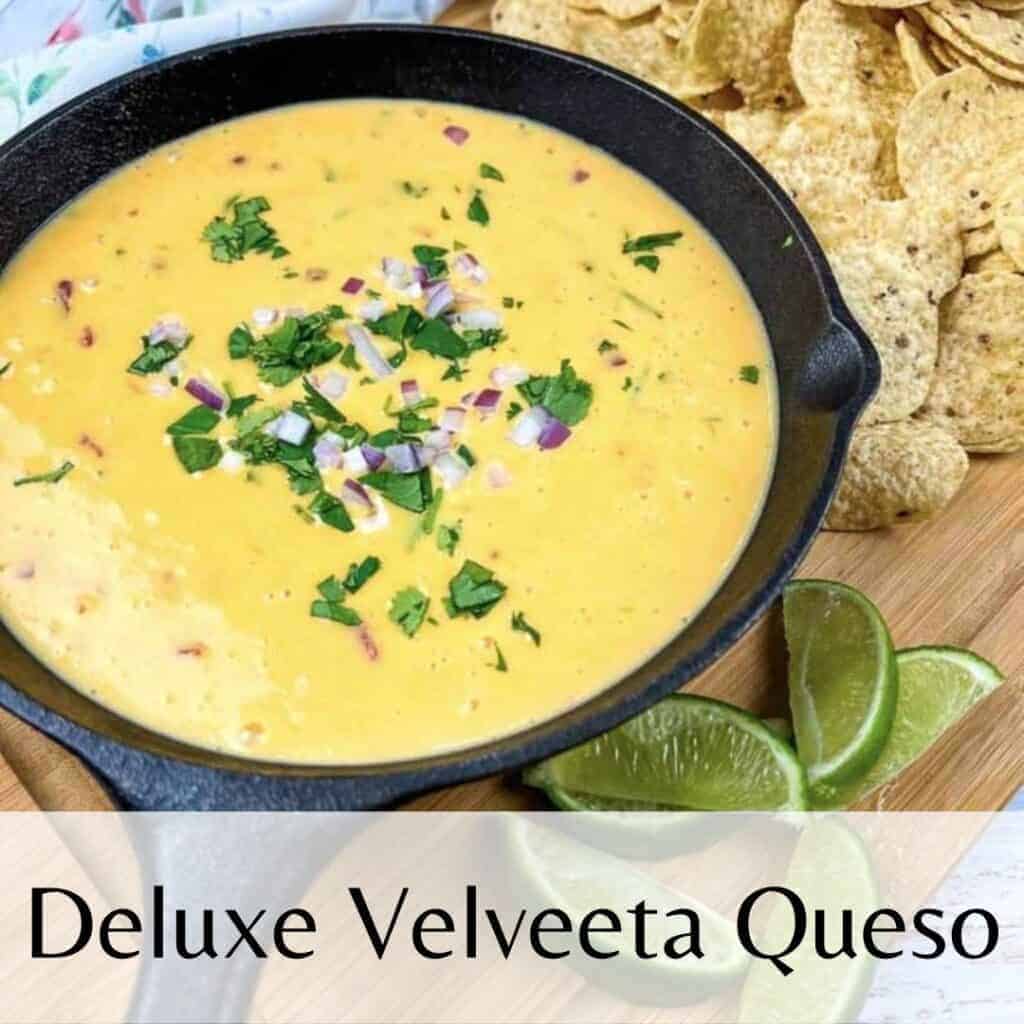 Deluxe velveeta queso in a skillet with tortilla chips.