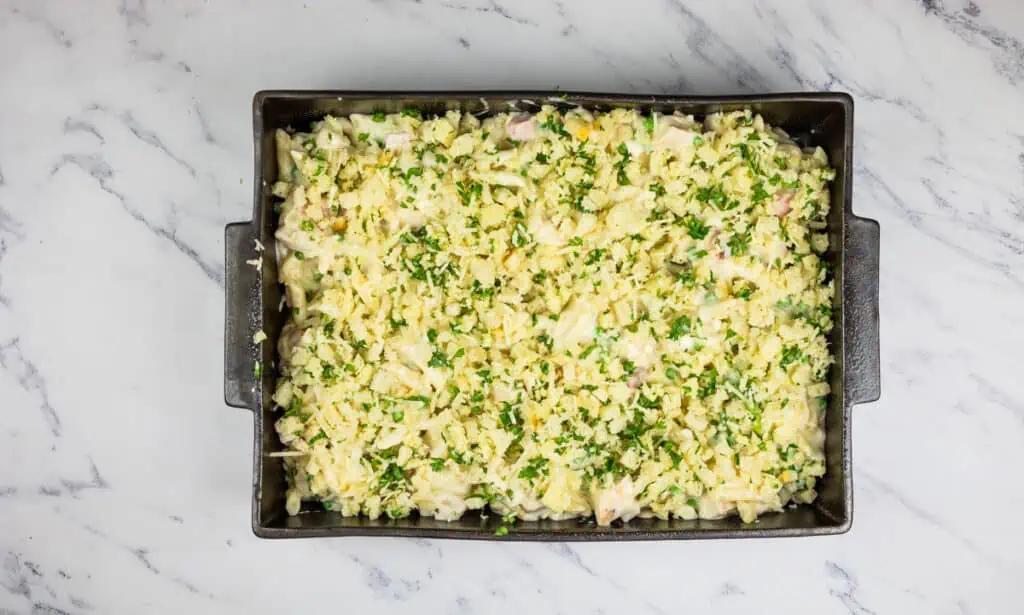 A baking dish filled with pasta and herbs.