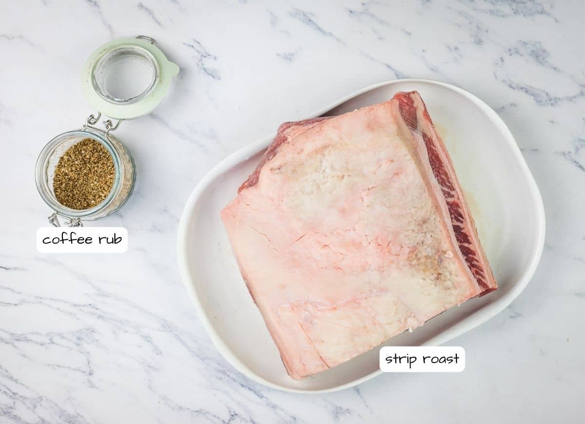 A plate with a piece of meat and spices on it.