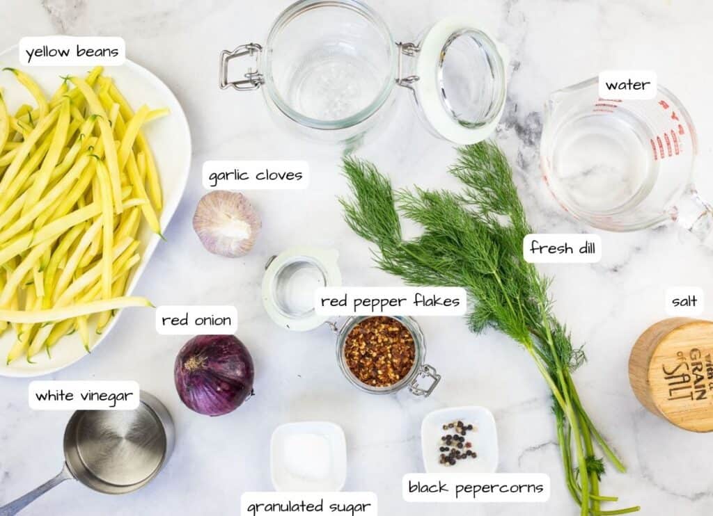 The ingredients for a green bean casserole are laid out on a marble table.