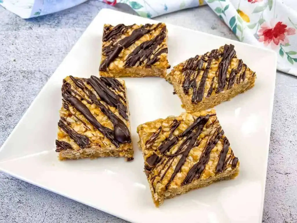 Peanut butter oat bars on a white plate.