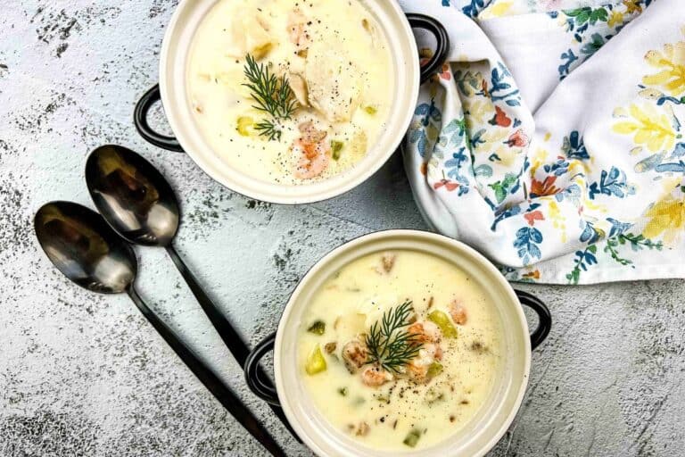 Two bowls of soup with sprigs of rosemary.