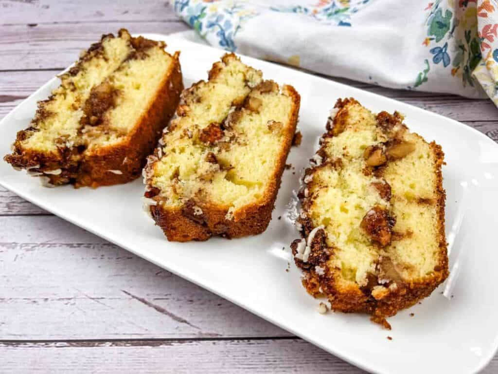 Three slices of banana bread on a white plate.