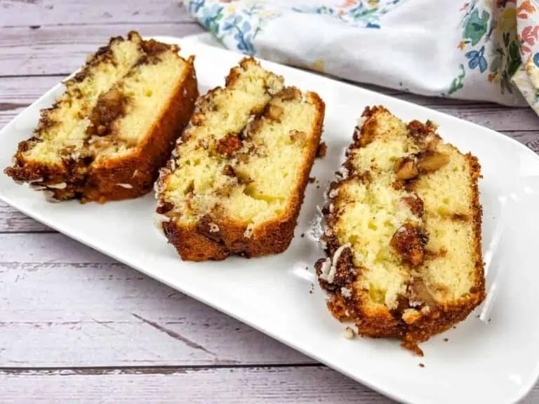 Three slices of banana bread on a white plate.
