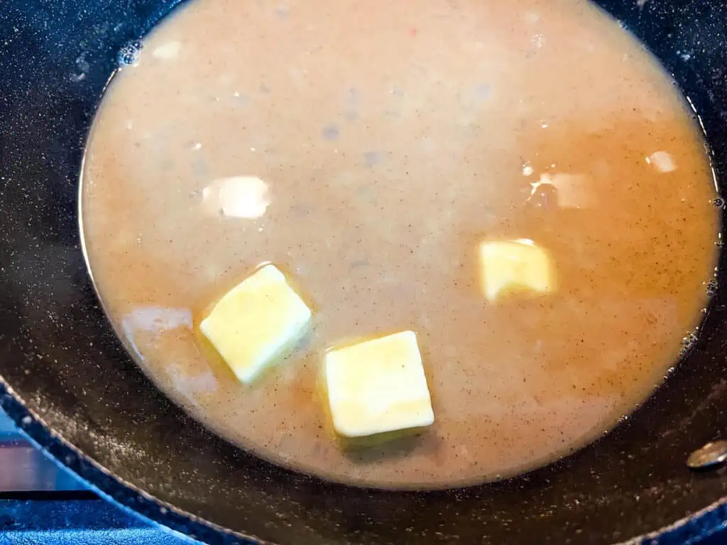 A frying pan with butter in it.