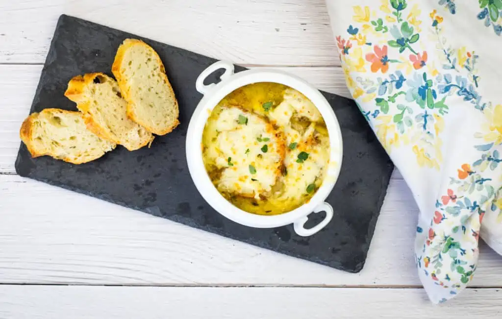 A bowl of soup and bread on a table.