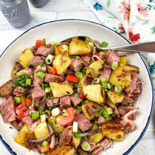 A bowl of Leftover Cottage Roll Hash on a table.
