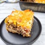 A square of John Wayne Casserole on a black plate.