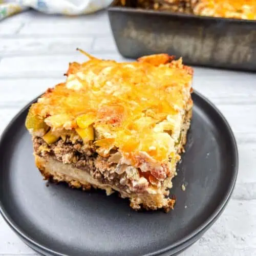 A square of John Wayne Casserole on a black plate.