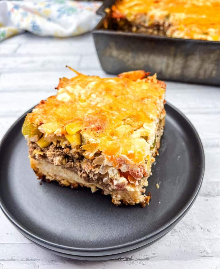 A square of John Wayne Casserole on a black plate.