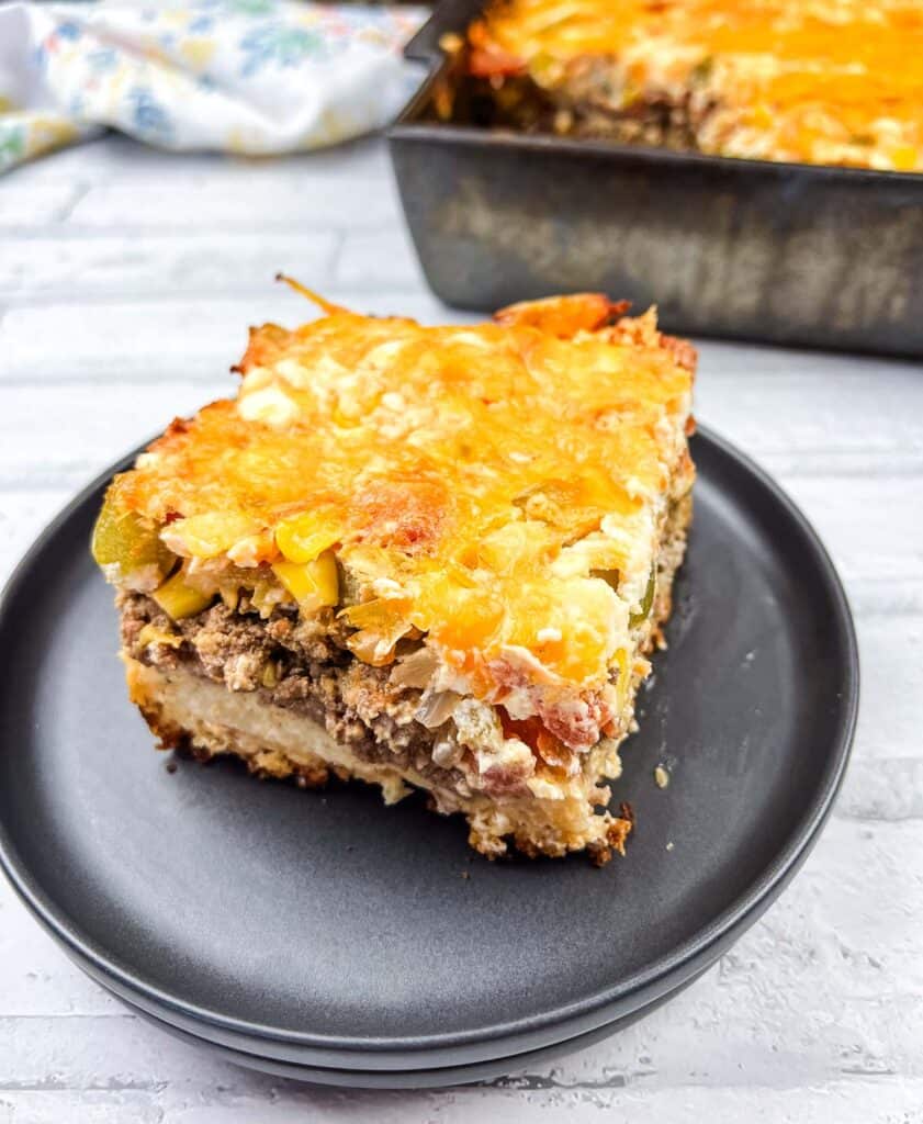 A square of John Wayne Casserole on a black plate.