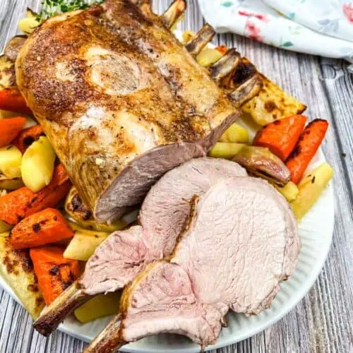 Roasted pork with carrots and potatoes on a plate.