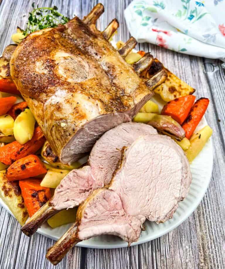 Roasted pork with carrots and potatoes on a plate.