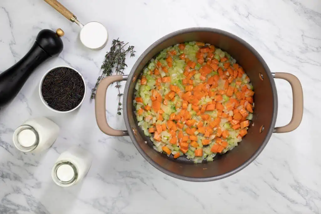 A pot filled with carrots and other ingredients.
