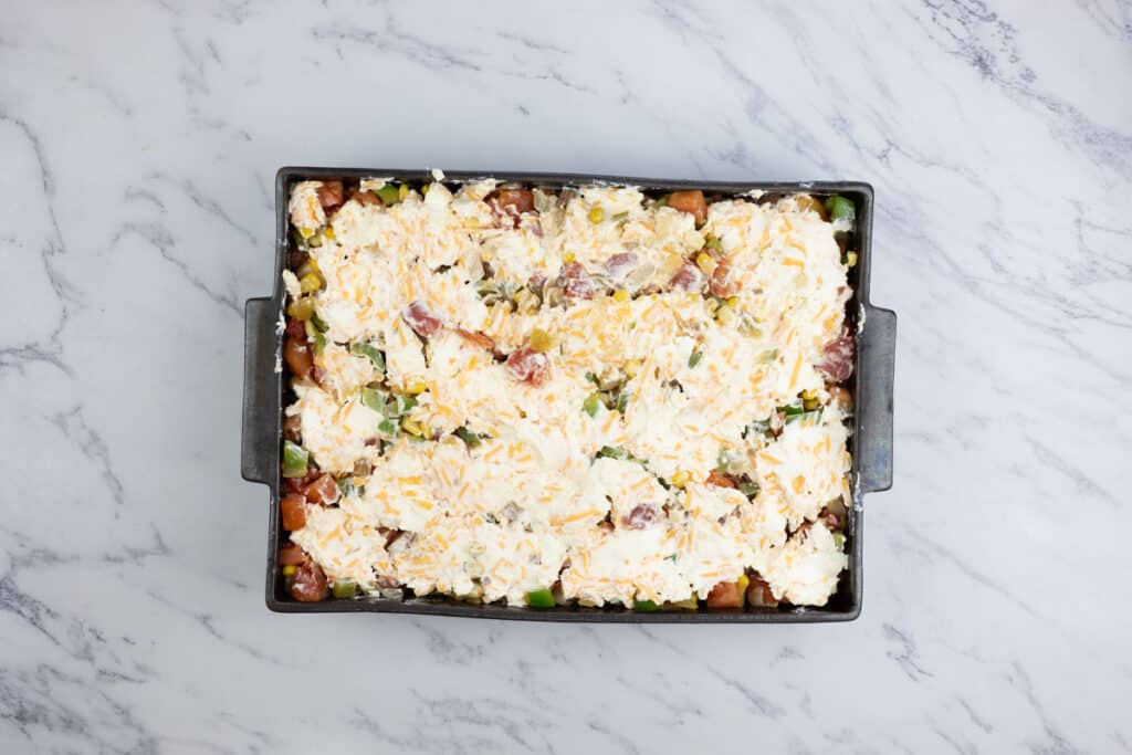 A casserole dish with cheese and vegetables in it.