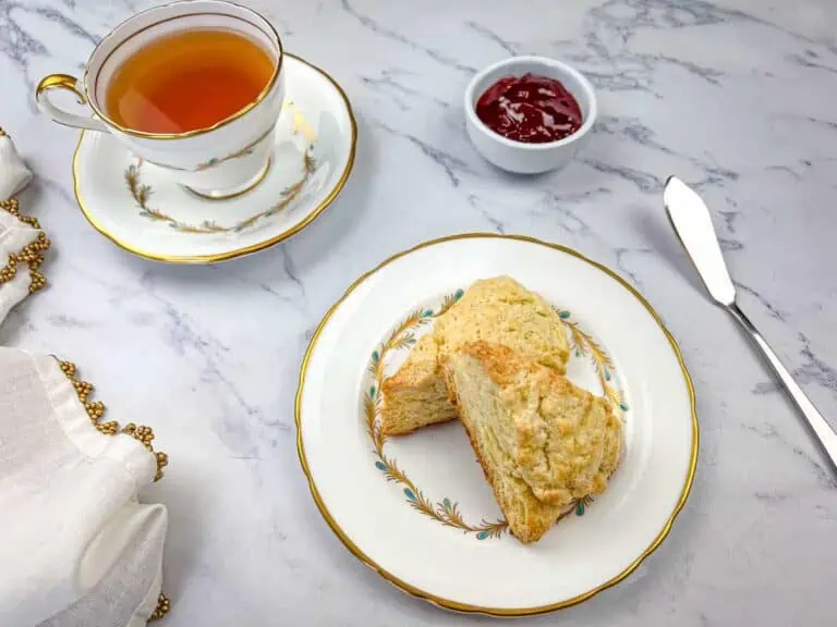 A plate of butter scones and a cup of tea.