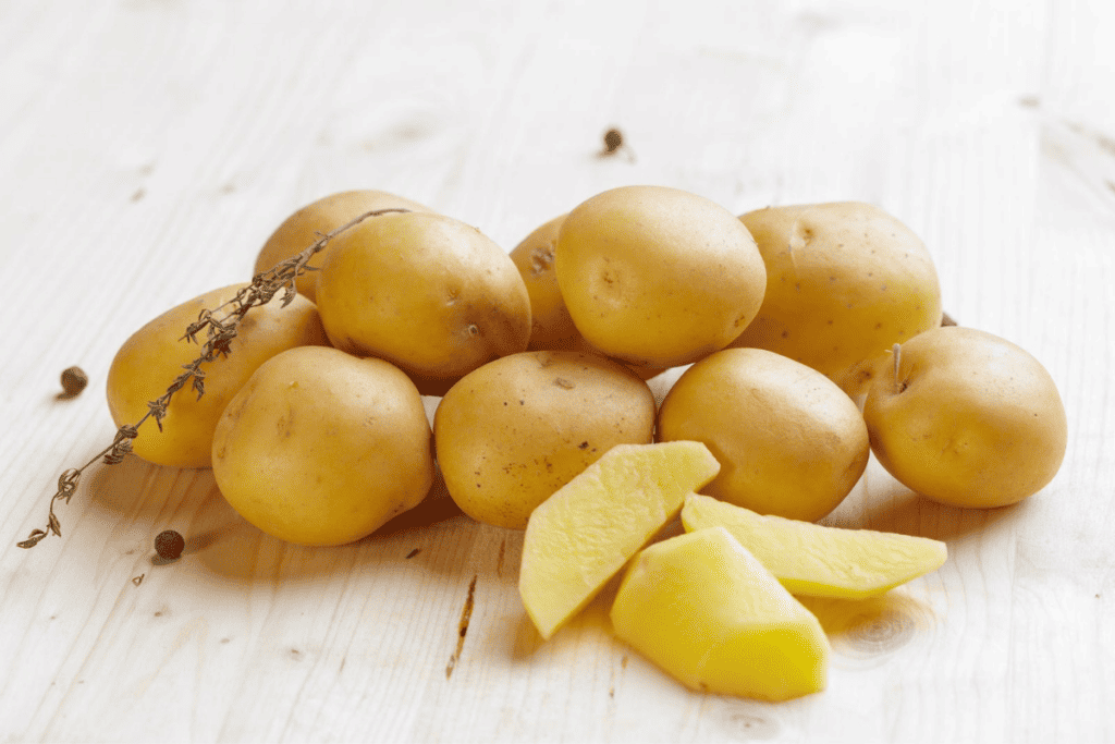 A pile of potatoes and slices of potatoes.
