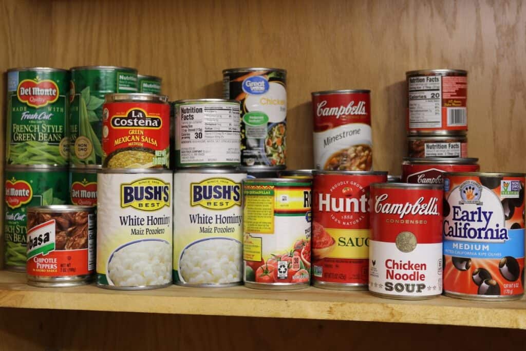 A shelf with cans of food.
