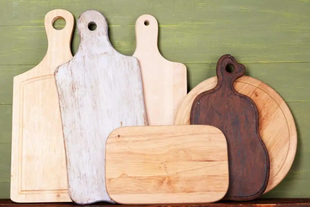 A group of wooden chopping boards on a wooden table.