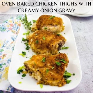 Oven-baked chicken thighs topped with creamy onion gravy, served on a white dish.