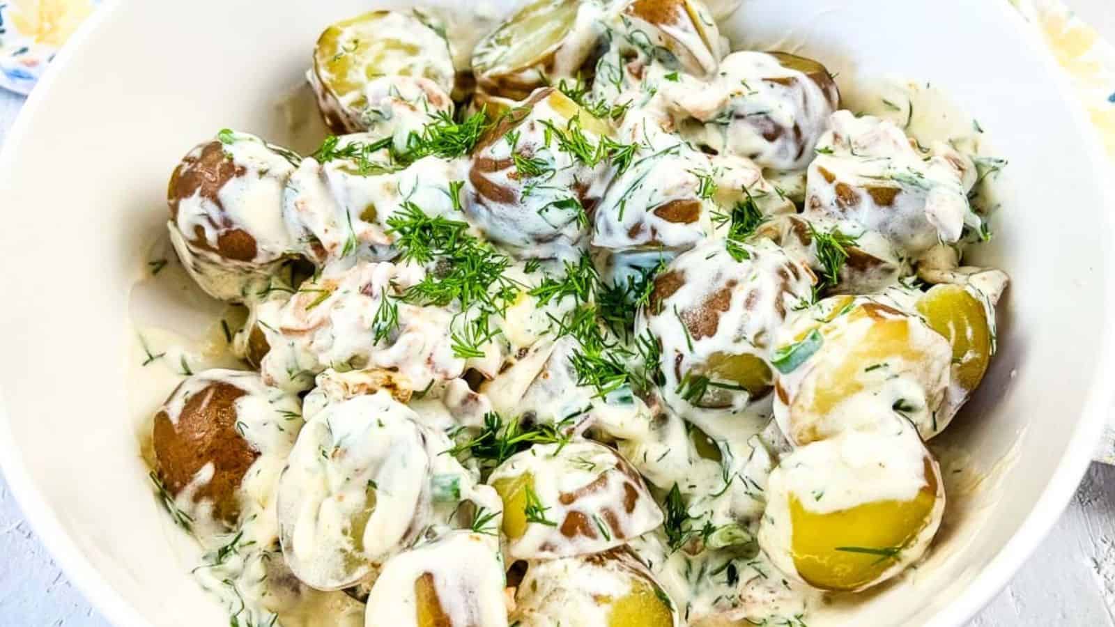 A bowl of potatoes with sour cream & bacon.