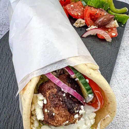 Greek Meatball Pita Sandwich on a black slate plate.