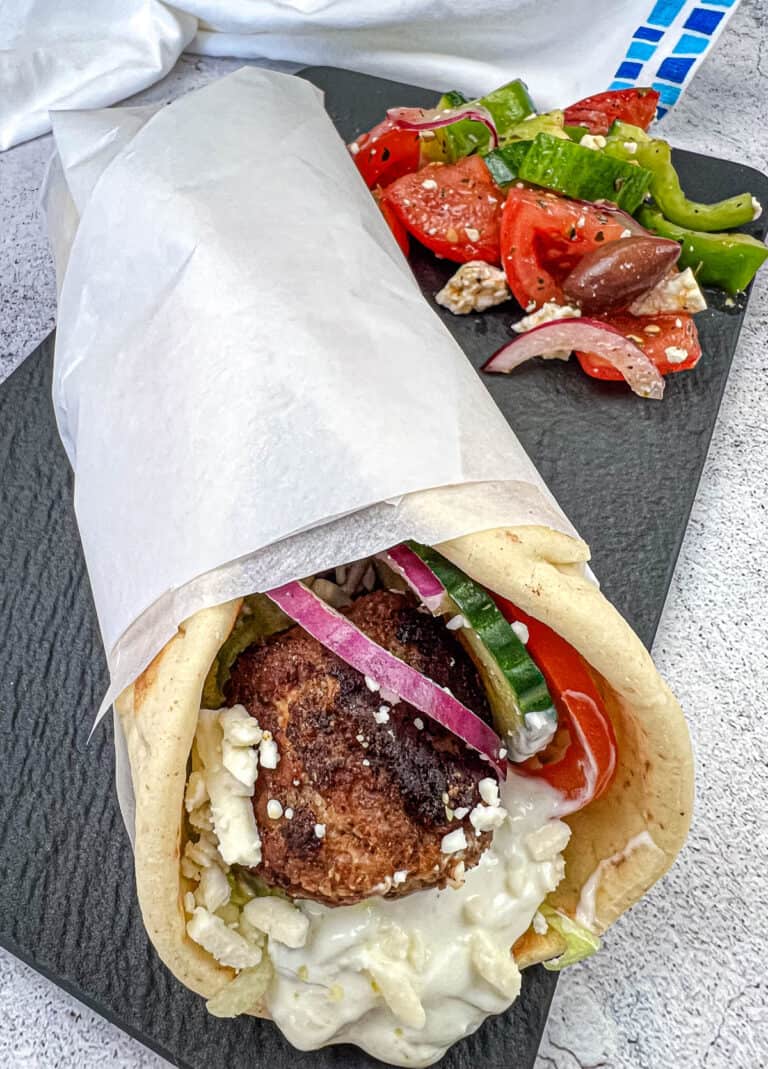 Greek Meatball Pita Sandwich on a black slate plate.