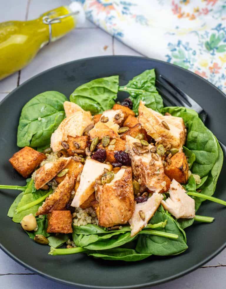 A salmon bowl served on a black plate.