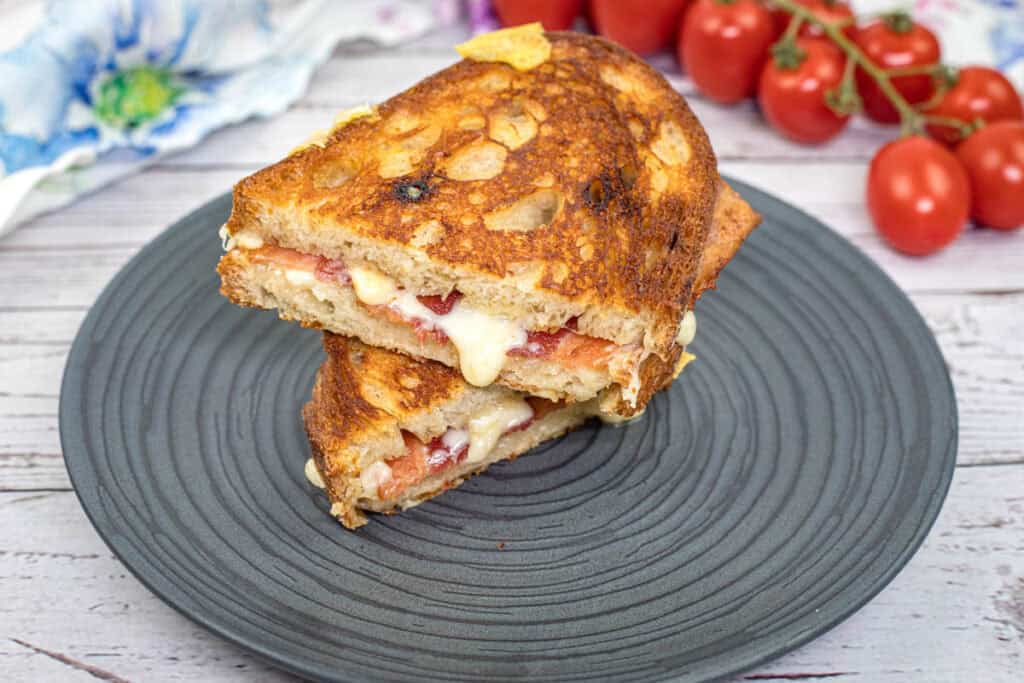Bacon Grilled Cheese Sandwiches with Hot Honey Butter on a black plate,