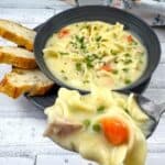 Turkey Noodle Soup in a bowl with a small portion on a spoon.