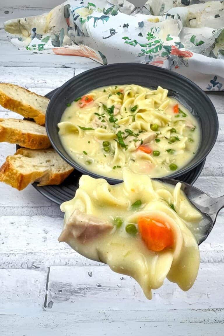 Turkey Noodle Soup in a bowl with a small portion on a spoon.