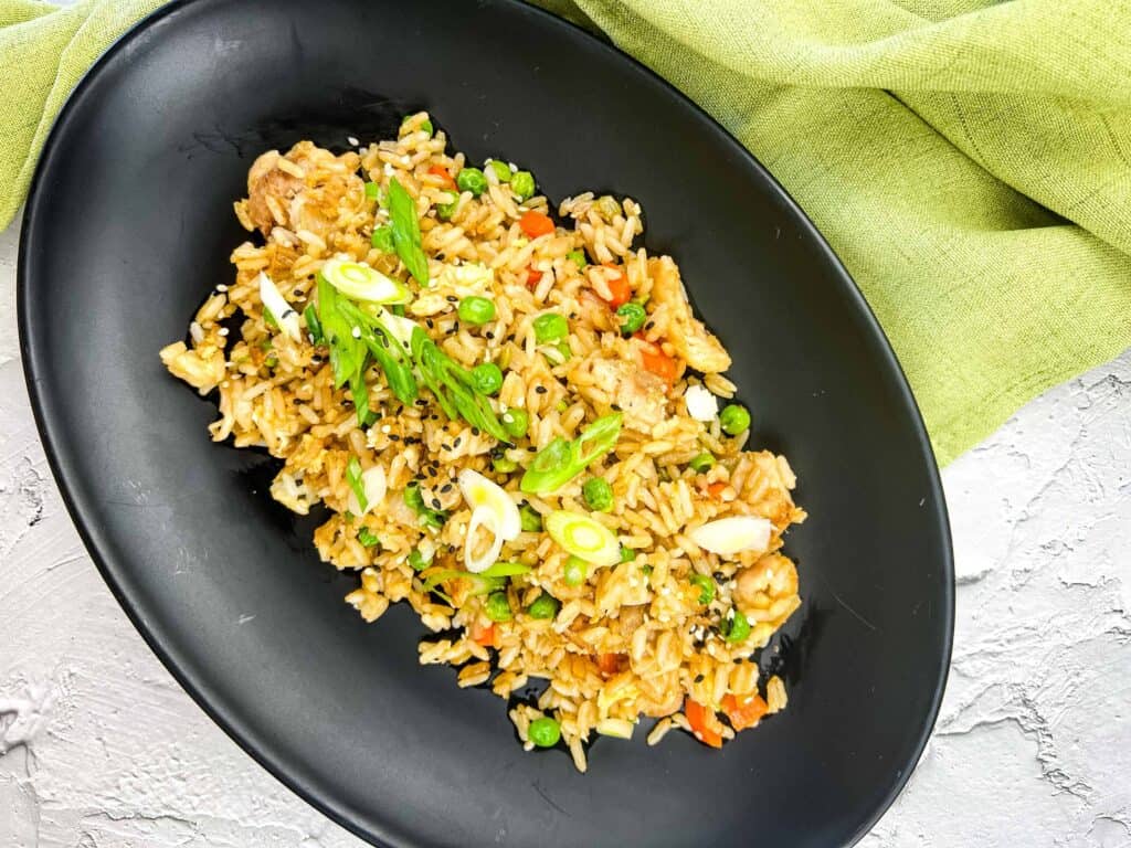 Top-down shot of Turkey Fried Rice on A Blackstone Griddle on a black plate.