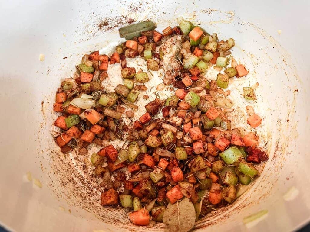 Stir in the zucchini, red and yellow bell peppers, jalape&ntilde;o, and garlic.