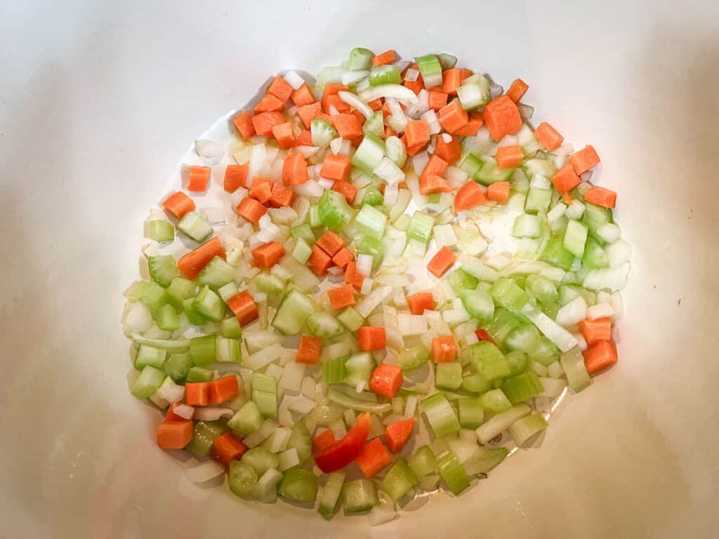 Cook the diced onion, carrots, and celery.