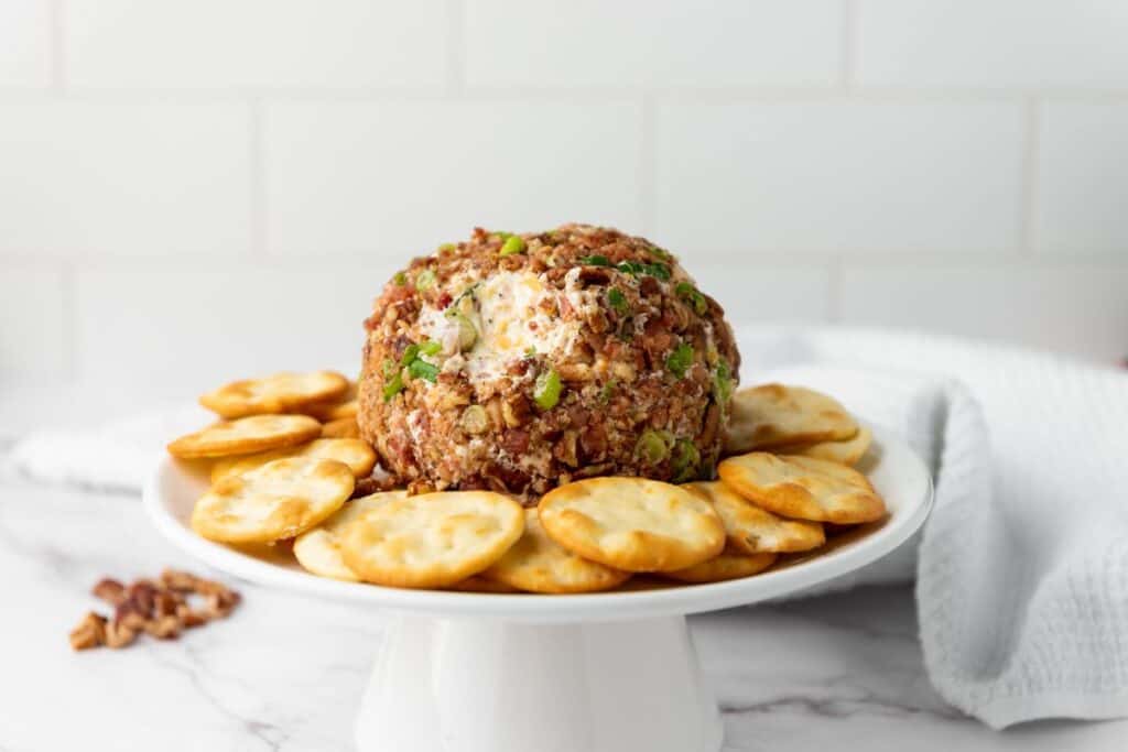 Pecan Bacon Cheeseball with crackers around.
