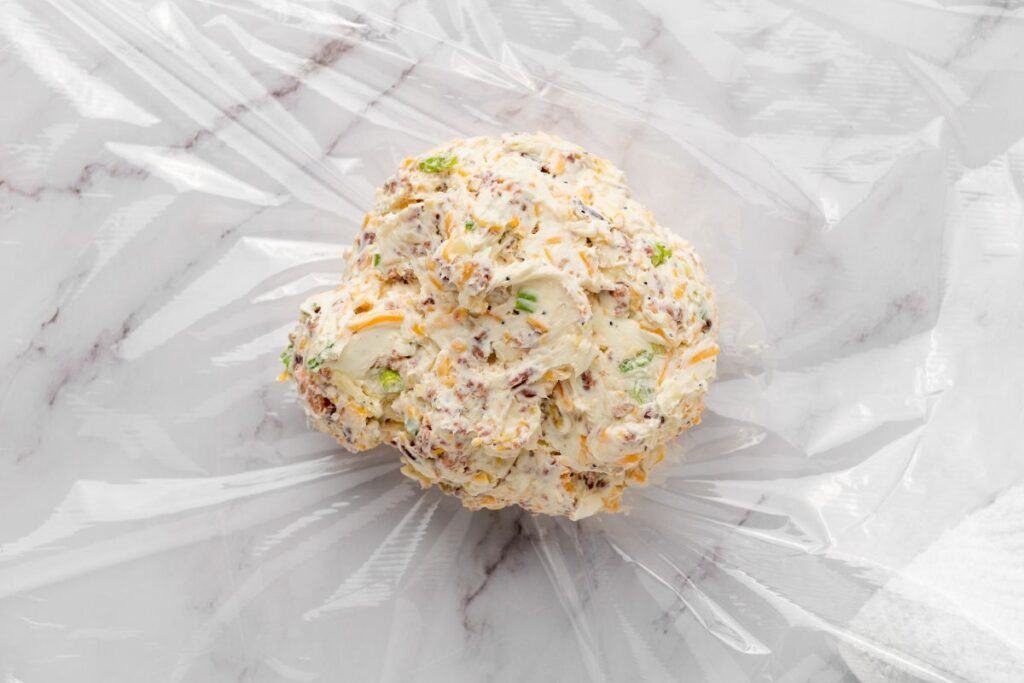 Wrap the cheese mixture tightly in the plastic wrap.