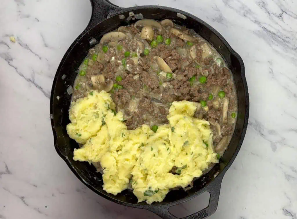 Spread the mashed potatoes over.