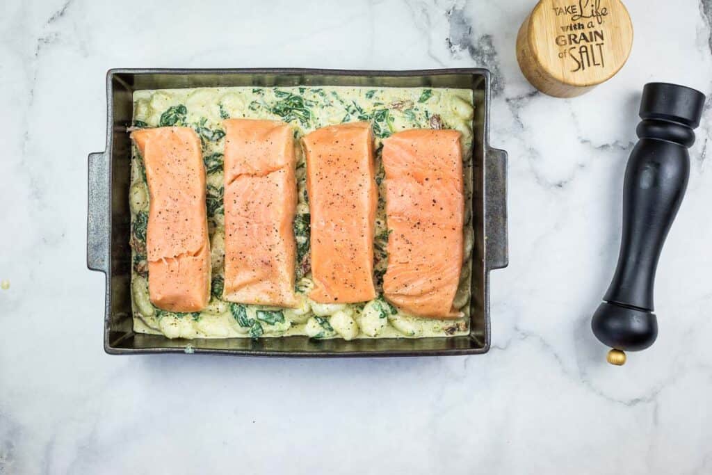 Place the salmon fillets on top of the gnocchi mixture.