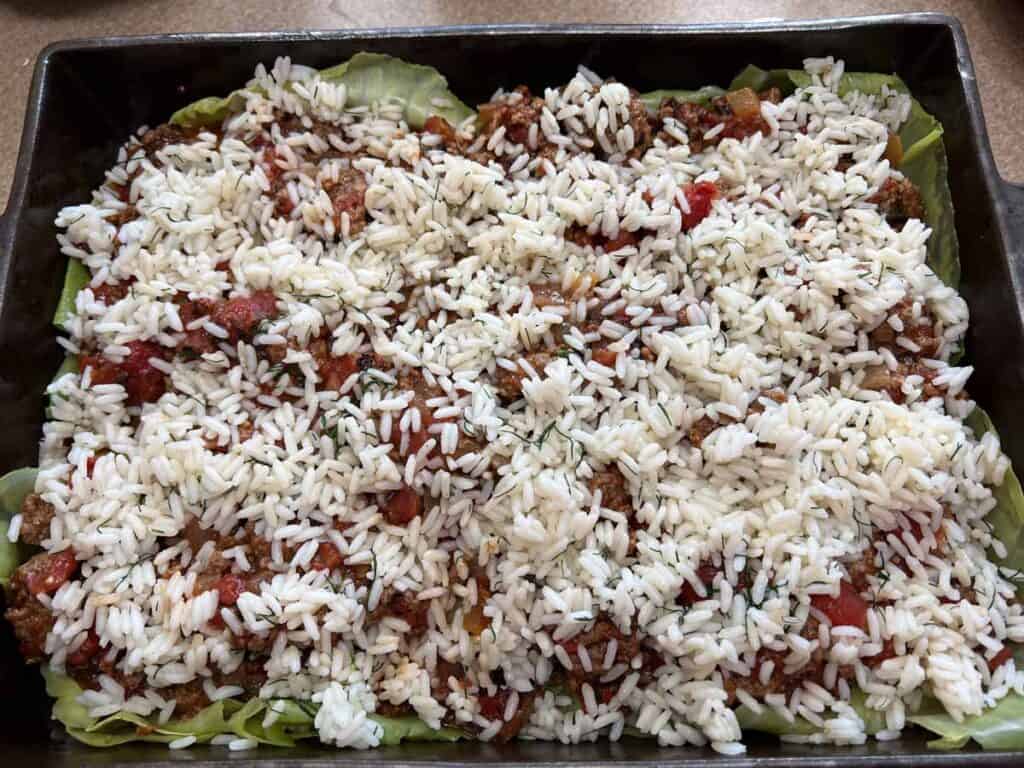 Spread the remaining sauce followed by the remaining rice.