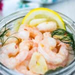 A jar with a pickled shrimp.