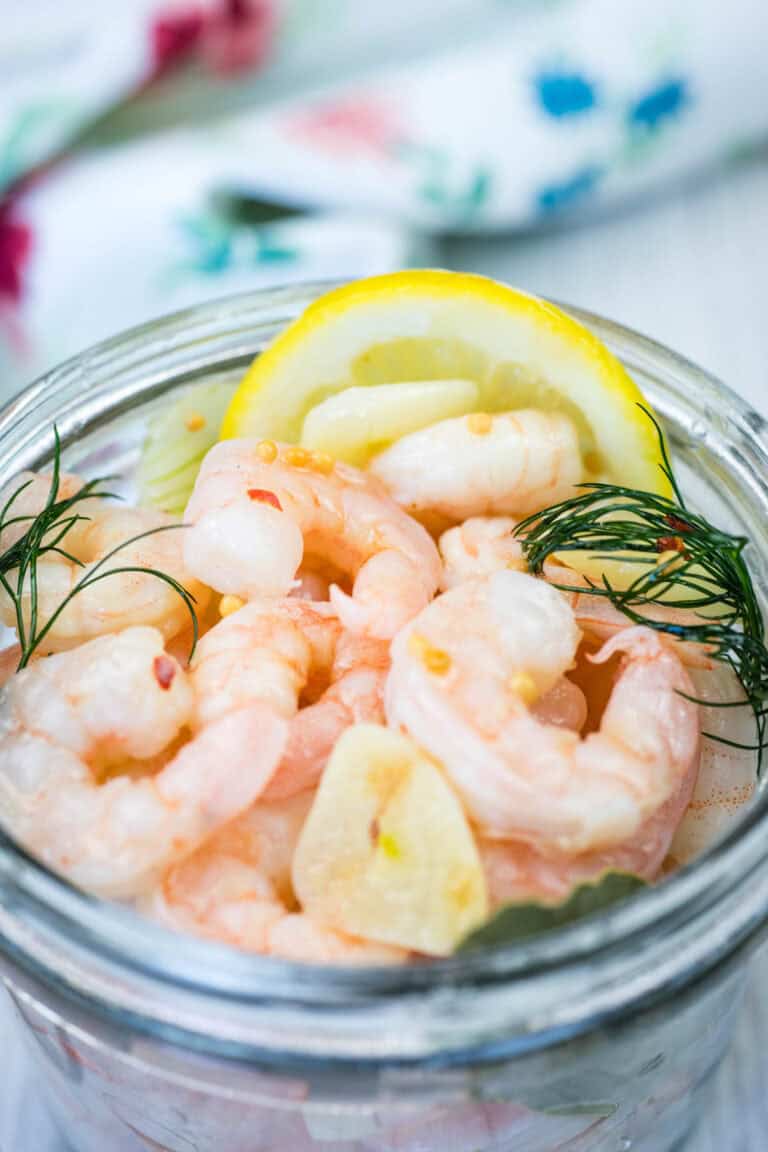 A jar with a pickled shrimp.