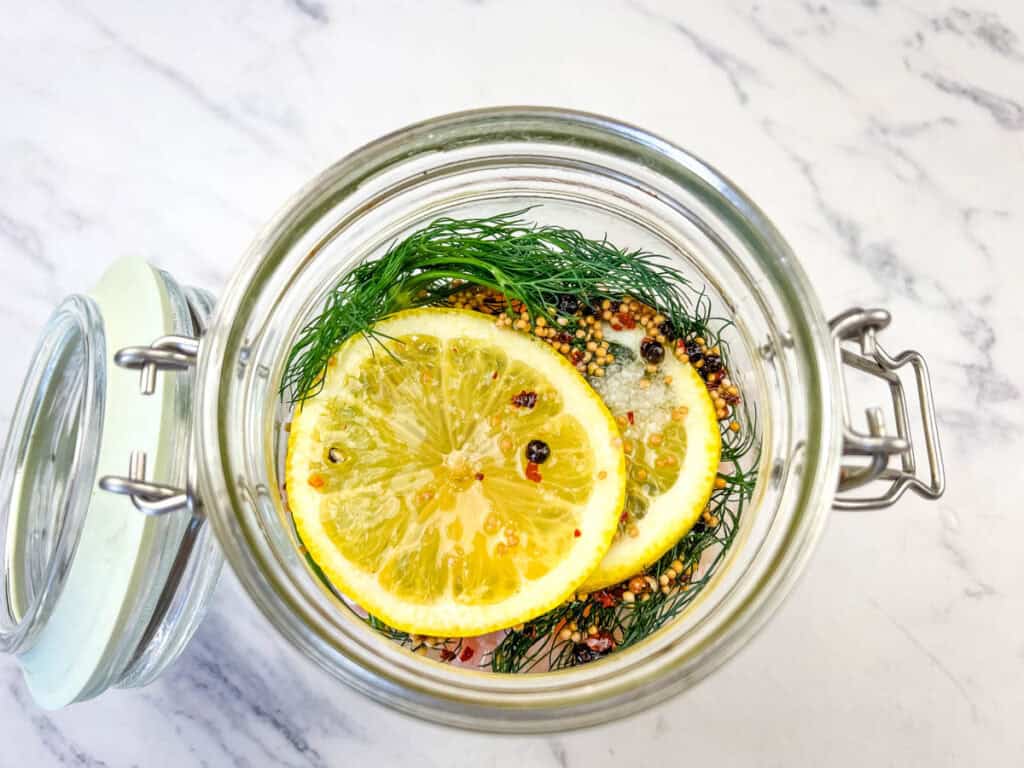 Top the shrimp and marinade with the remaining dill, onion, and lemon.