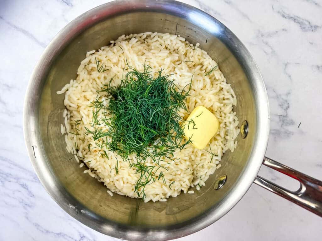 Stir in the butter and chopped dill in the cooked rice.